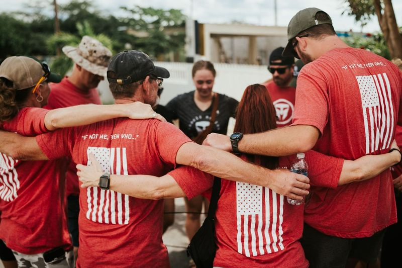 Group wearing Travis Manion Foundation shirts, standing in unity and support for Veterans.