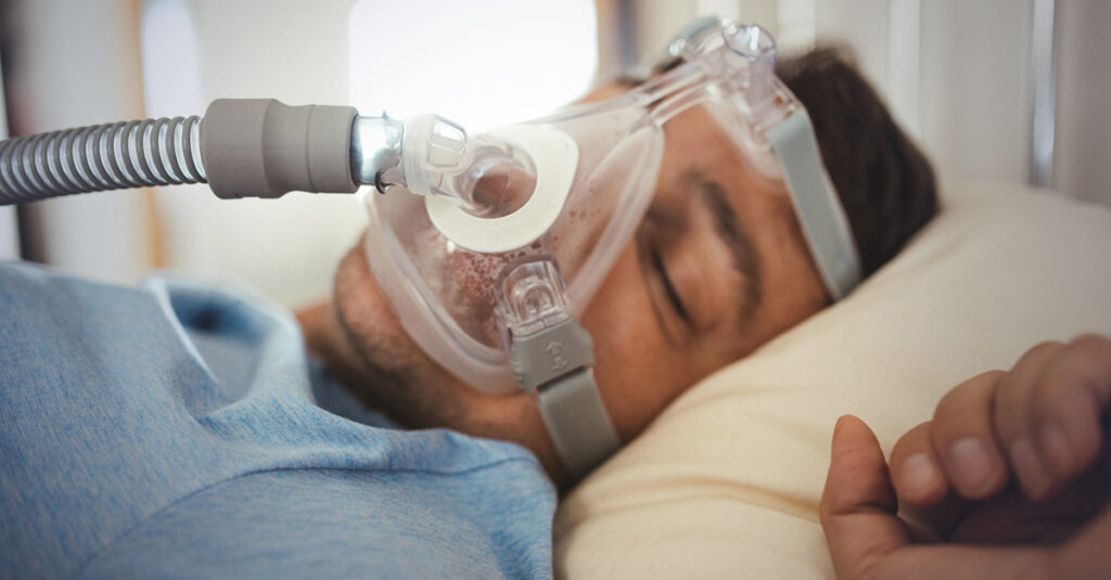 Veteran wearing a cpap mask used to manage symptoms of obstructive sleep apnea.