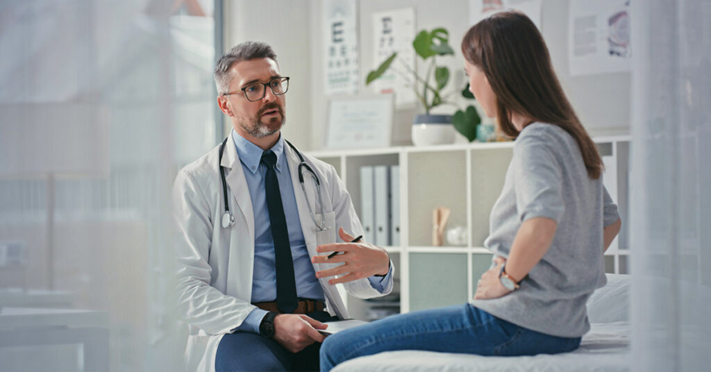 Doctor speaking with veteran about IBS symptoms.
