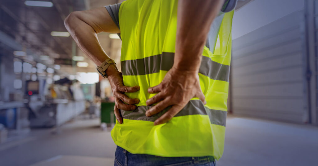 Veteran at work experiencing back pain.