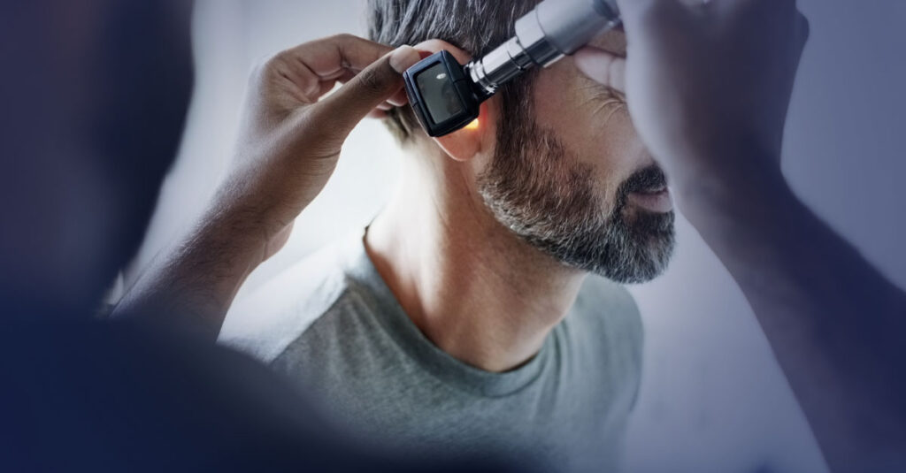 Veteran getting a hearing exam from a medical professional.