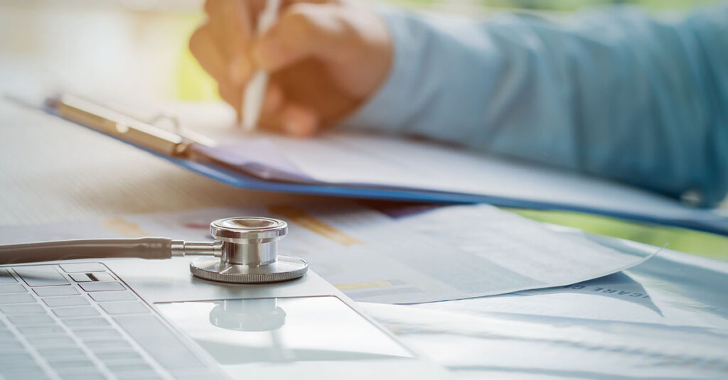 Medical professional writing a VA nexus letter example.