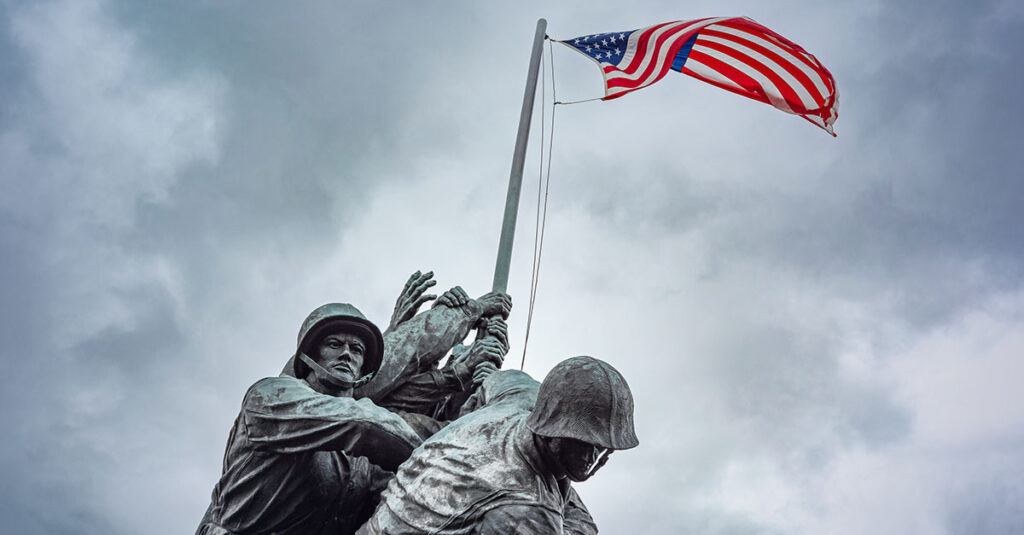 Military statue with American flag.