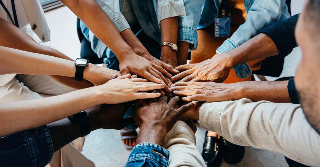 Hands in for team cheer.