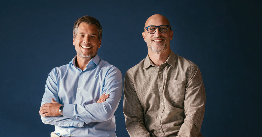 Two veterans smiling after a successful form submission.