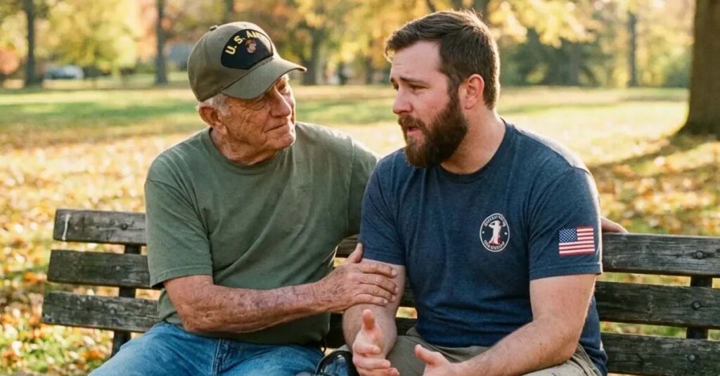 Veteran sitting on a bench offering support to a younger veteran.