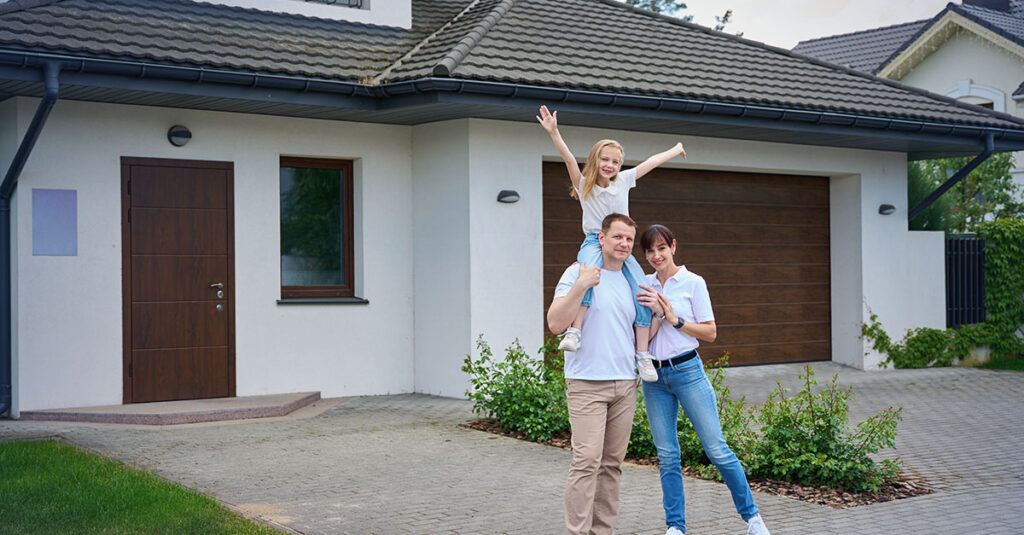 Veteran and family standing outside of their home.